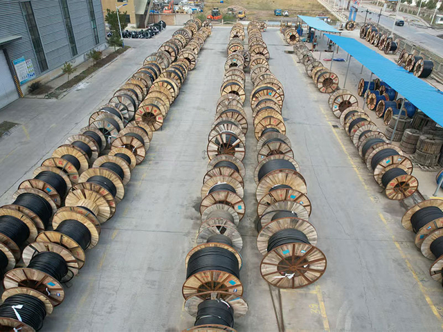 Large outdoor storage area with drums of xlpe cable and mineral insulated cable